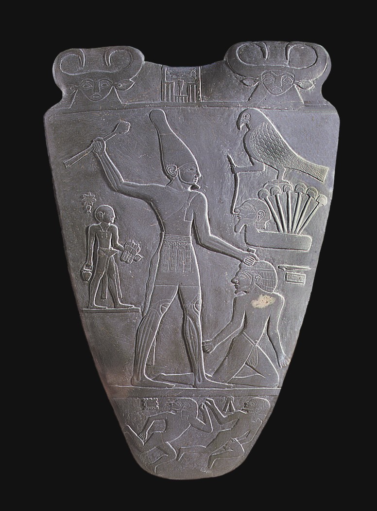 Figure 6-1: The Palette of Narmer chronicles a victory of King Narmer over his enemies. Here, the pharaoh clobbers a kneeling enemy.